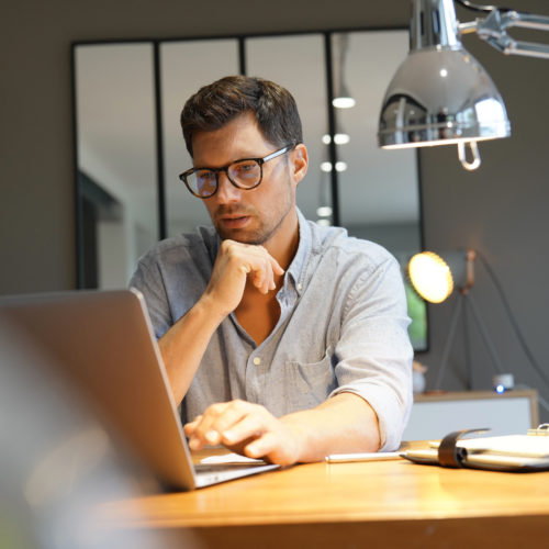 Middle-aged man working on laptop in office
